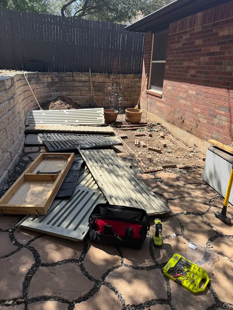Patio construction debris stacked for removal
