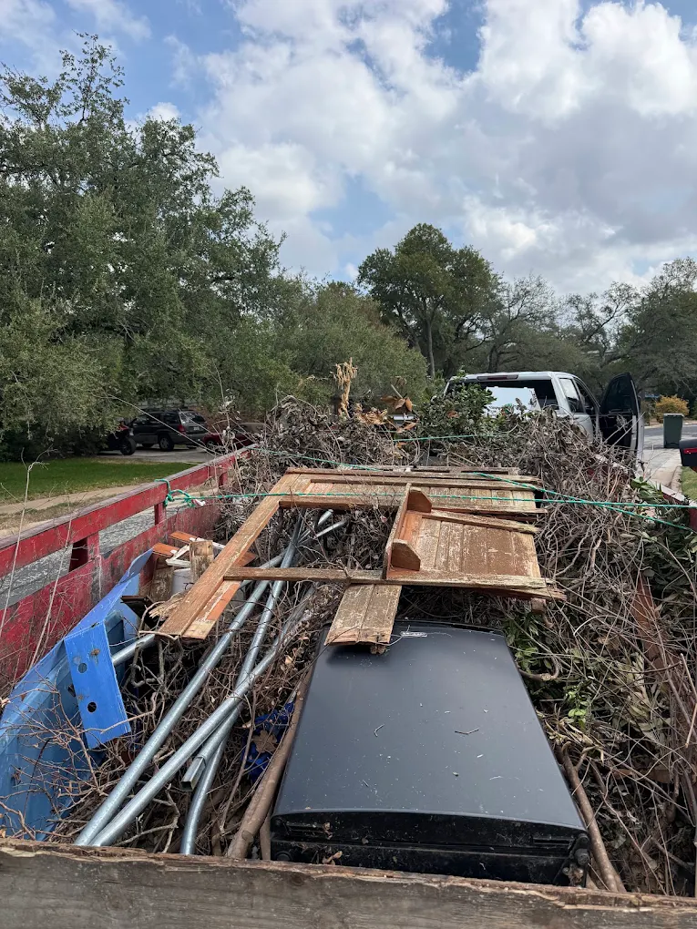 Truck bed loaded with brush and debris
